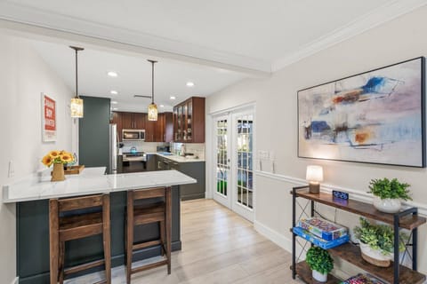 Updated kitchen with stone counters, just steps from the pool area.