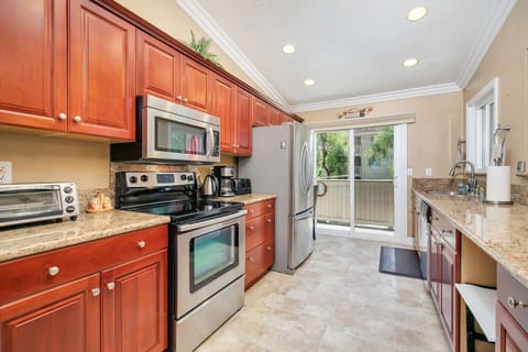 Updated kitchen with custom cabinetry, granite counters, and stainless appliances