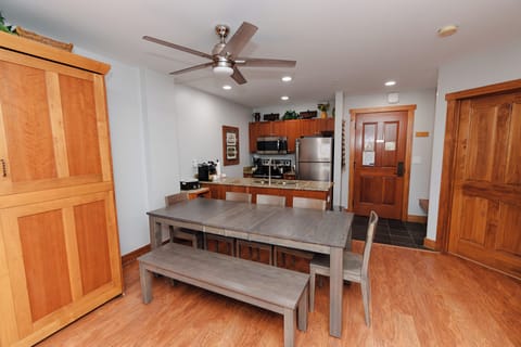 Your open-concept kitchen and dining area features warm wood cabinetry, granite countertops, and a spacious table perfect for gathering with family and friends.