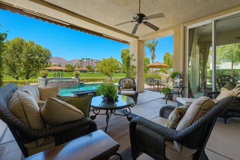 Luxurious patio seating with views of the pool, golf course and mountains