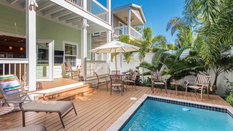 The fully fenced private back pool area with chaise lounges and outdoor dining...