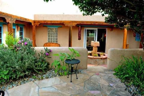 View to sunken courtyard with grill, covered portal area extends outdoor living in any kind of weather