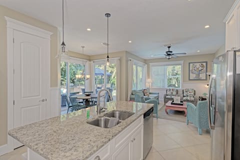 Large picturesque windows fill the living, dining and kitchen with natural lighting