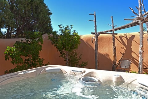 Private hot tub, adobe wall enclosed, offers starry night skies and easy conversation. A gate allows access from other rooms