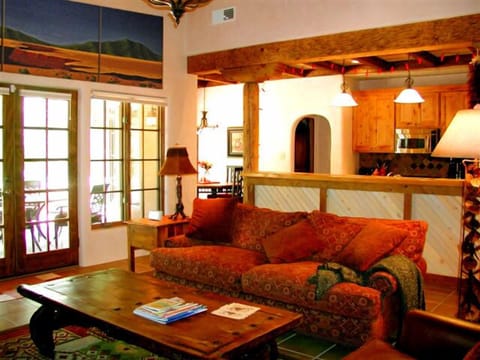 Living room view to kitchen and portal (covered patio)