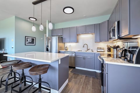 Updated modern kitchen with 3 bar stools at the island.