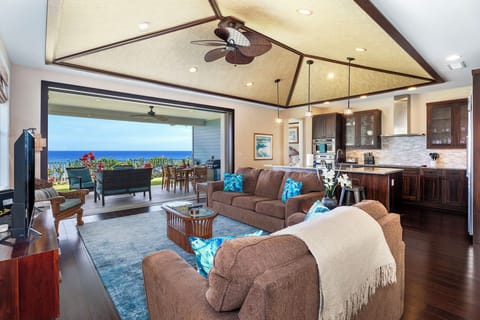 Living room with Wall of sliding doors that open to expansive ocean views
