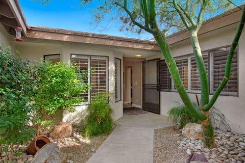 From walkway into home has lovely landscaping!