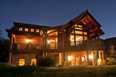 Your mountain retreat awaits as twilight settles over this stunning log home. Watch the warm glow spill from every window while you relax on your private deck, breathing in the crisp evening air.