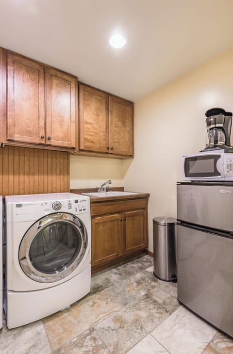 laundry area with frig, micro, coffee maker, sink