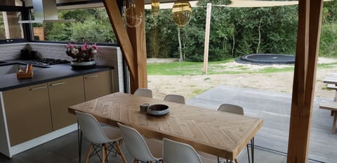 The huge glass fronts and timber merge the holiday home with the nature reserve.