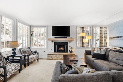 The spacious sofa is a great place to curl up and enjoy a movie or sporting event on the flat screen TV with SONOS sound system.