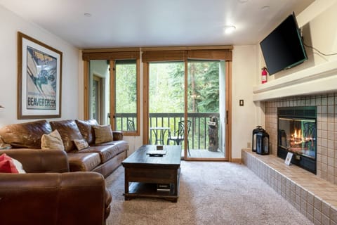 Living Room with Flat Screen TV and Access to the Balcony with Seating for 2