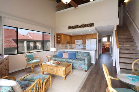 A view from the lanai doors to the living & dining area. Stairs lead to the loft