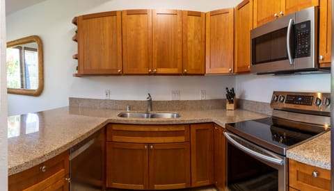 Kahala 312 Kitchen - Full kitchen with oven and glass electric cooktop, microwave, double sink, dishwasher and full refrigerator allow you all the comforts of home and plenty of amenities to be able to cook whatever local food you find!