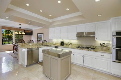 The kitchen is open and bright - counter seating to mingle with the cook as they prepare the meal.