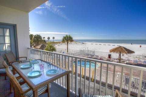 Enjoy a meal on your private balcony overlooking the pool and Madeira Beach