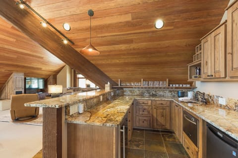 Loft - TV, Seating, card table, Bar and fridge and adjacent sleeping space