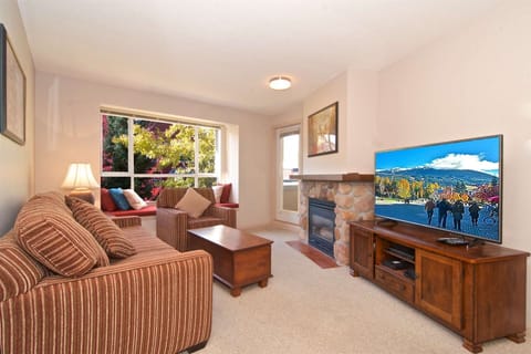 Comfortable living area with sofa bed, window seat and 52" TV