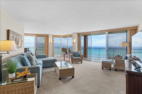 Unwind in this stunning oceanfront living room where floor-to-ceiling windows frame endless sea views and coastal breezes fill your tranquil retreat.