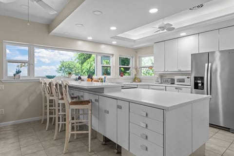Kitchen with stainless steel appliances and breakfast bar