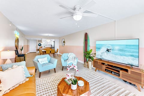 A spacious living room with a massive tv and elegant decor for pure relaxation