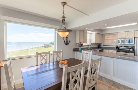 Dining table seats six with an oceanfront view