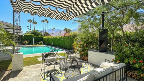 Pergola With Lounge Seating Overlooking Large Pool and Spa