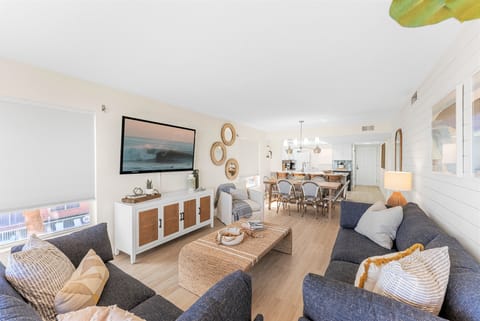 Living room featuring a sofa, smart TV with streaming apps, and bright design this space is perfect for movie nights,