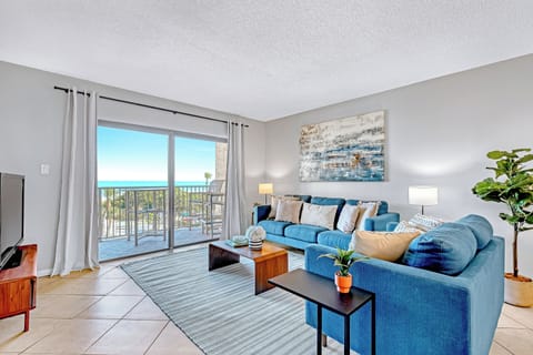 Bright and spacious living room with a stunning ocean view, stylish decor, and comfortable seating.