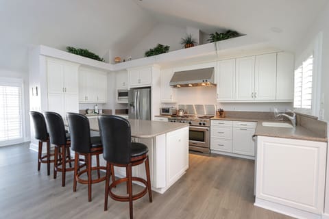 Kitchen with stainless steel appliances and breakfast bar