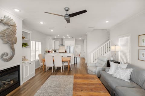 The open concept living kitchen and dining area are beautifully decorated and full of beachy charm that will make you feel right at home