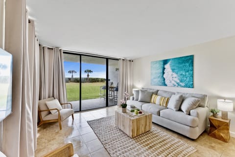 Bright and modern living room with a stunning ocean-inspired painting.
