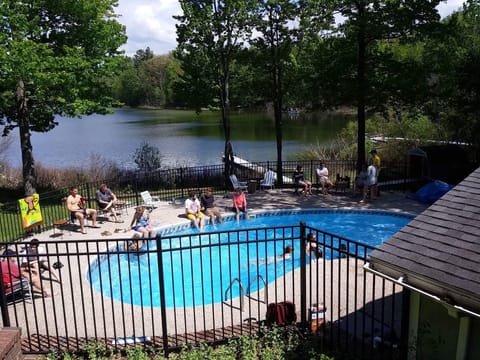 Outdoors - Pool (unavailable in winter), fire pit, charcoal grill, dock, kayak, canoe, row boat, life vests, grassy yard, fishing rods, patio, outdoor dining table & chairs, badminton, softball equipment, basketball hoop.