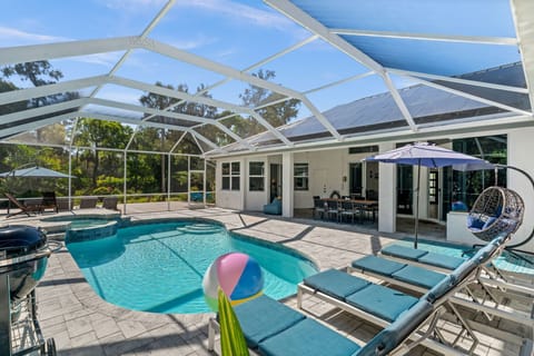 Private screened pool & spa oasis surrounded by tropical landscaping