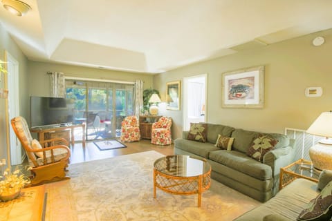 Relax & unwind in this comfortable living room with screened-in porch overlooking the inlet!