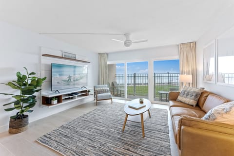 Stylish and inviting living space with large windows overlooking the beach