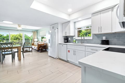A chef's dream with stainless steel appliances, bright cabinetry, and a clean, modern design.
