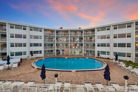 Relax by the centrally located courtyard pool as the evening sky sets a calm, coastal mood.