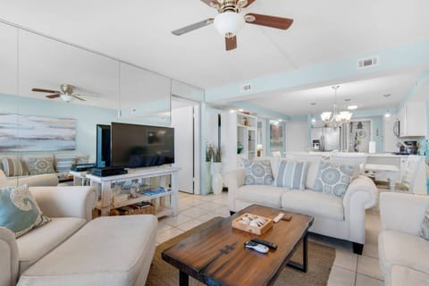 The living room has cozy couches and a large flat-screen T.V. to relax at the end of the day.