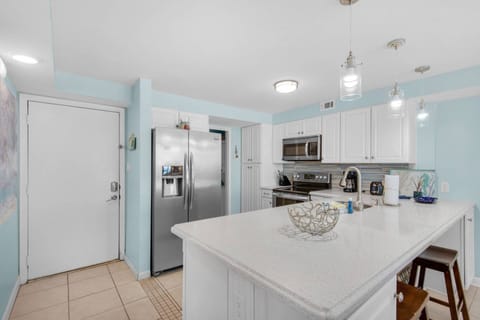 The kitchen is fully stocked and equipped with stainless steel appliances.