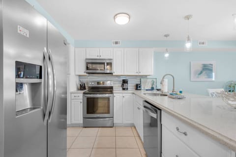 The kitchen is fully stocked and equipped with stainless steel appliances.