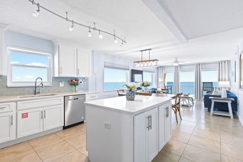 A modern kitchen with a stunning ocean view, perfect for cooking and entertaining.