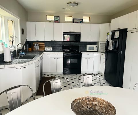 Kitchen and dining area with access to back deck. - Kitchen and dining area with access to back deck.