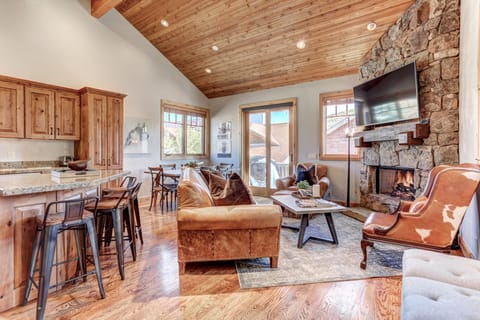 Living room with fireplace, 55" HD Smart TV, dining area and private deck