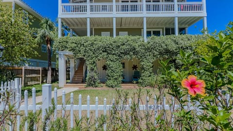 Wonderful front yard with tons of flowering jasmine. Under the house is storage for your kayaks and outdoor shower. First floor has bedrooms and bathroom, and top floor has the kitchen/living room.