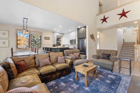 Spacious living area with ample seating, vaulted ceilings, TV with a Blu-ray player, and fireplace.