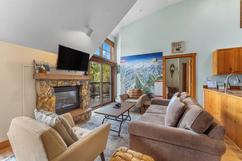 Cozy up by your stone fireplace while enjoying mountain views from the bright living area with vaulted ceilings.