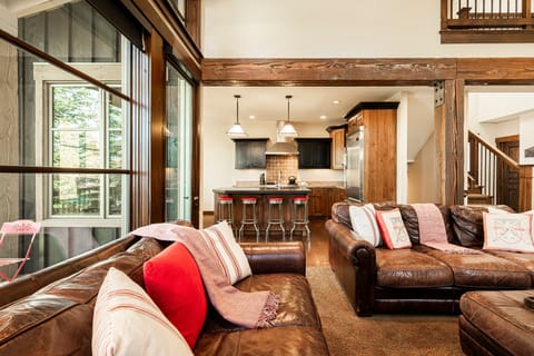 Open living space with rustic beams and mountain views