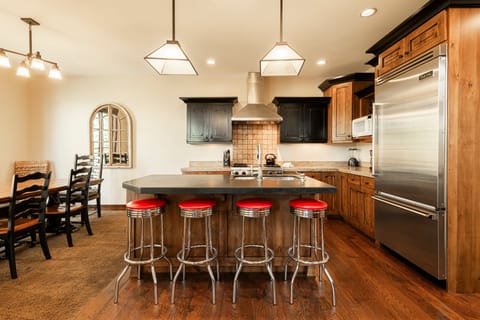 Gourmet kitchen with bar seating and stainless appliances
